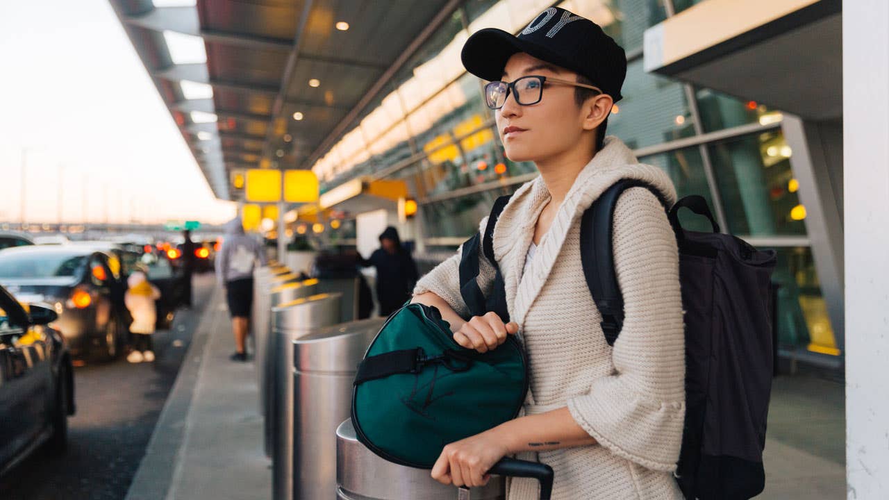 woman waiting outside airport