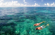 family snorkeling in the ocean