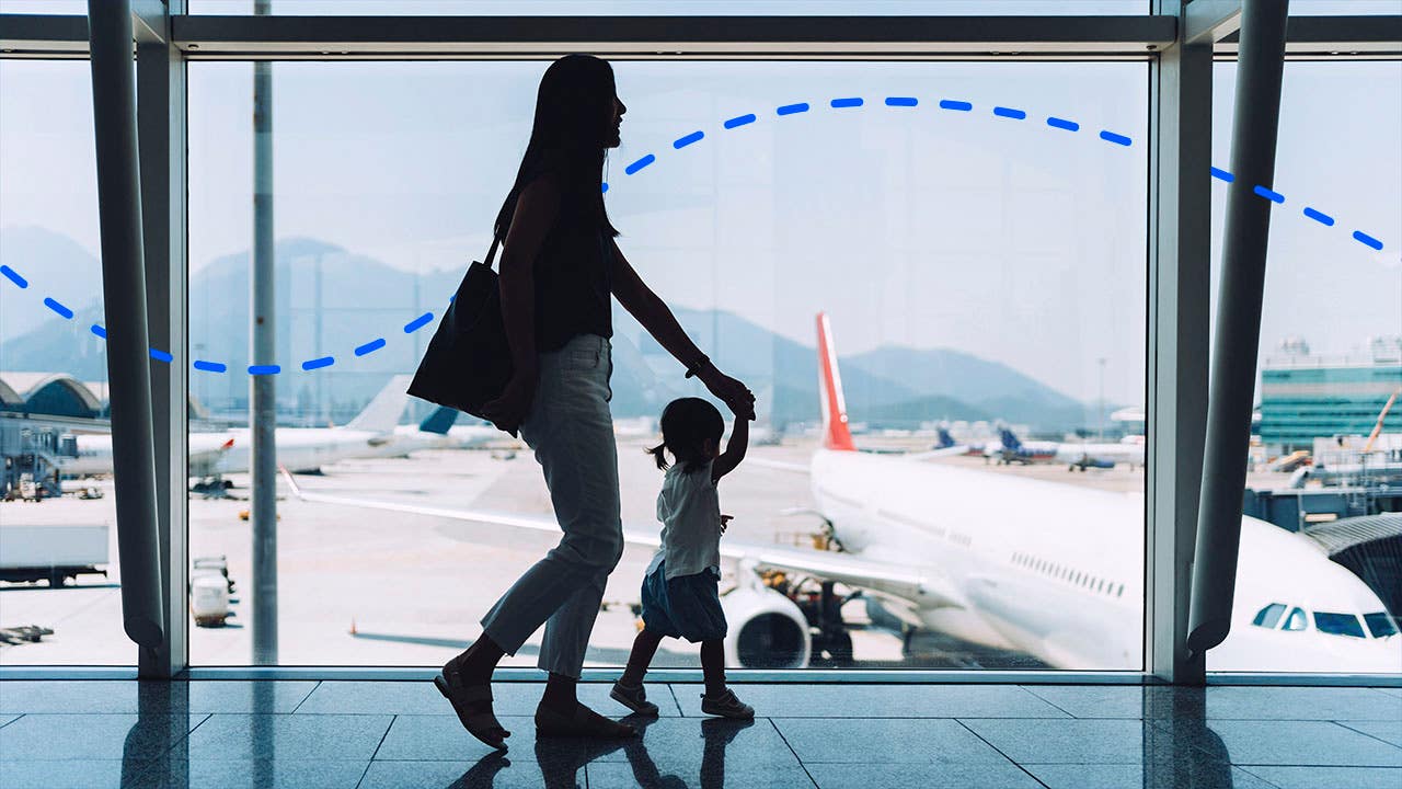A woman walking in the airport with her young daughter