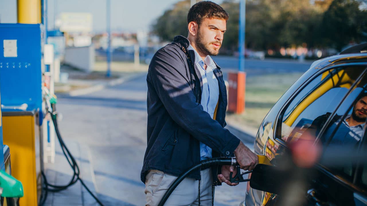 man pumping gas