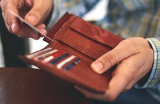 man pulling card out of wallet