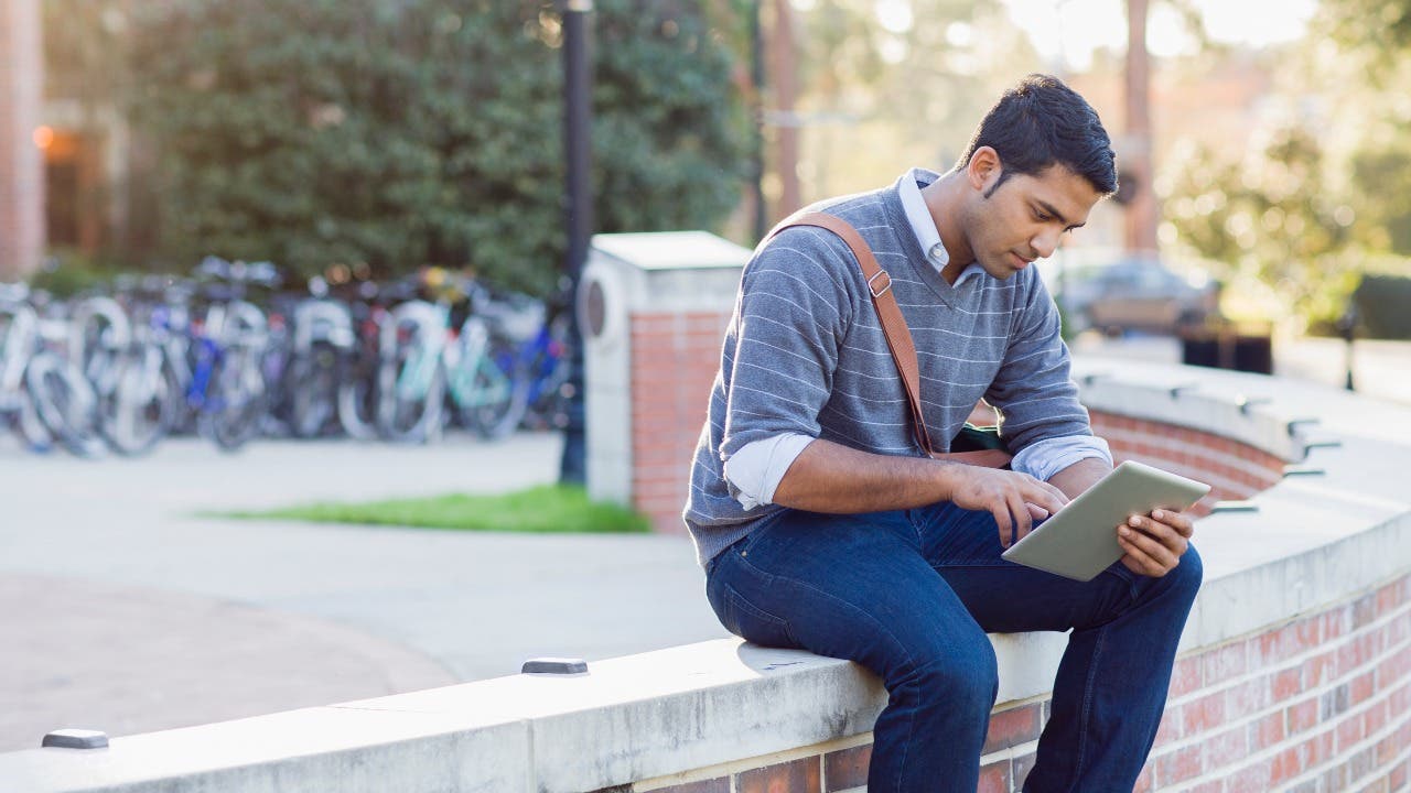 College student sits outside on campus