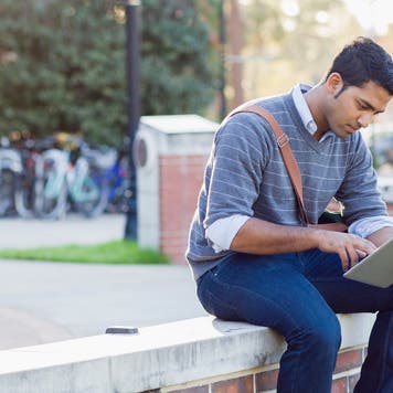 College student sits outside on campus