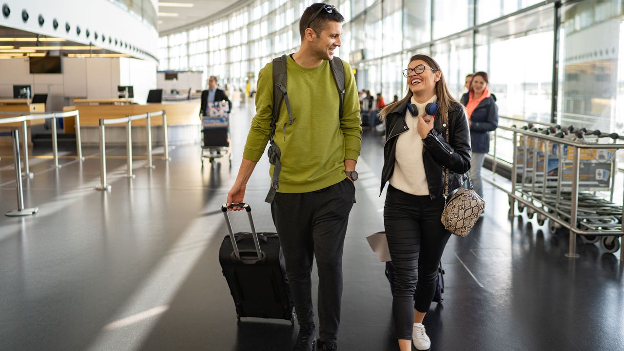 couple walking through airport