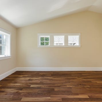 Wooden floor and bare walls in empty bedroom