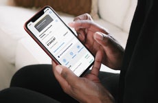 person looking at american express digital checking account on phone