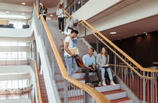 Students hang out on college stairs