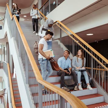 Students hang out on college stairs