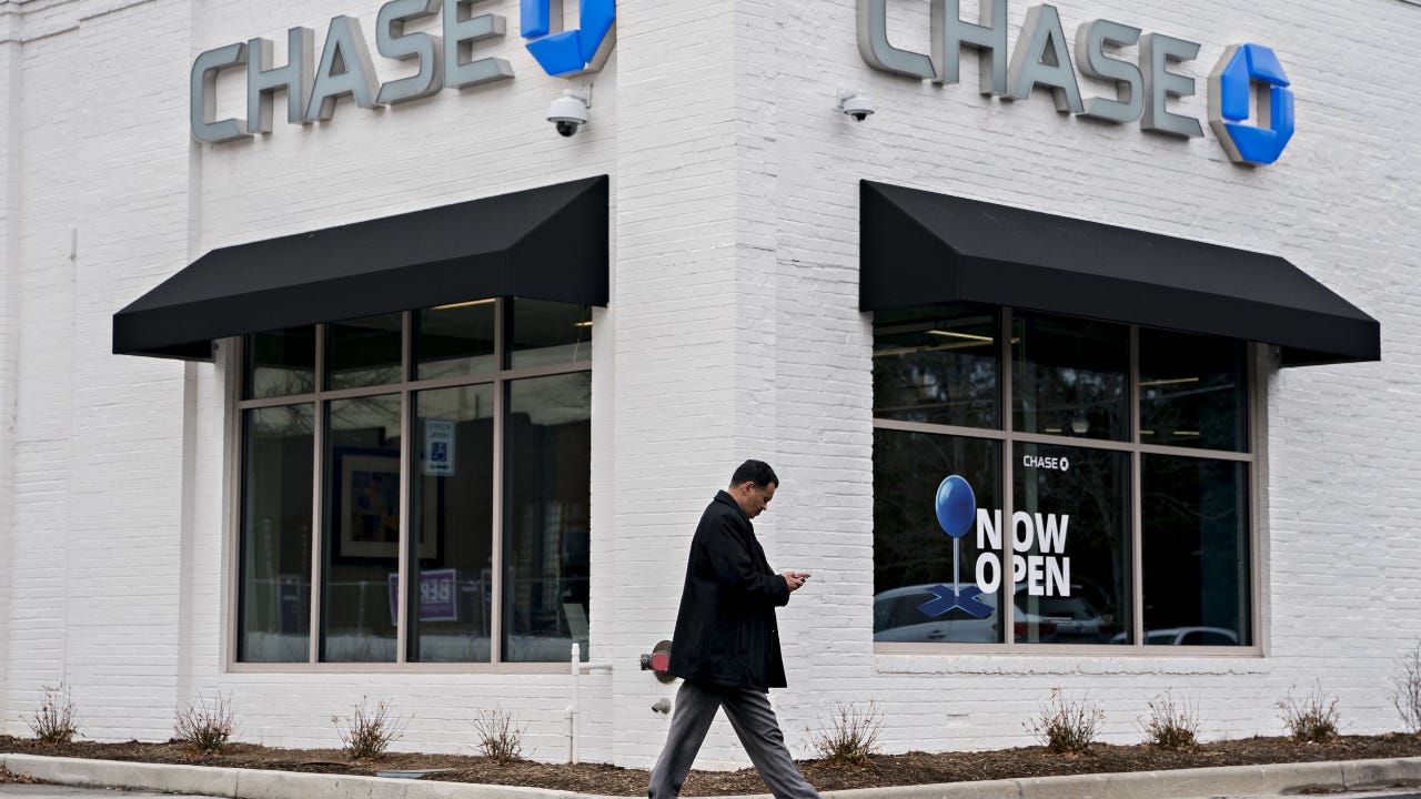 Man walks by JP Morgan branch