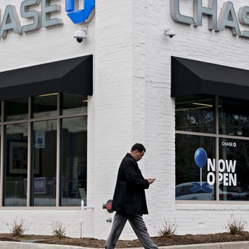 Man walks by JP Morgan branch