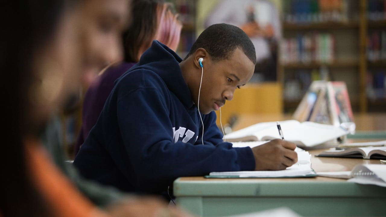 High school student studies in the library