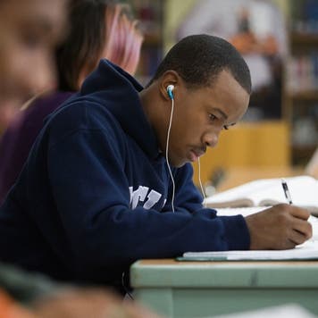 High school student studies in the library