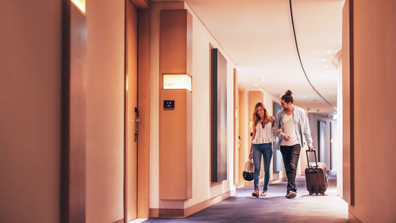 couple walking in hotel hallway