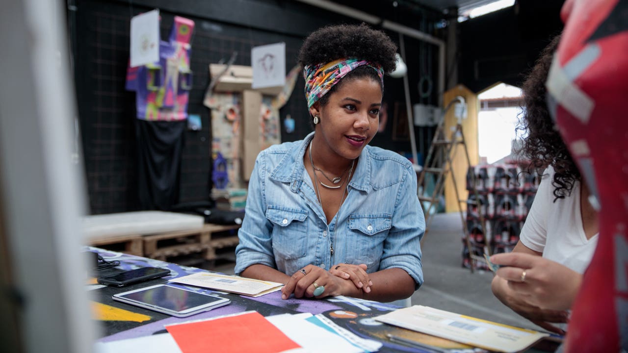 woman talking to colleague in design studio