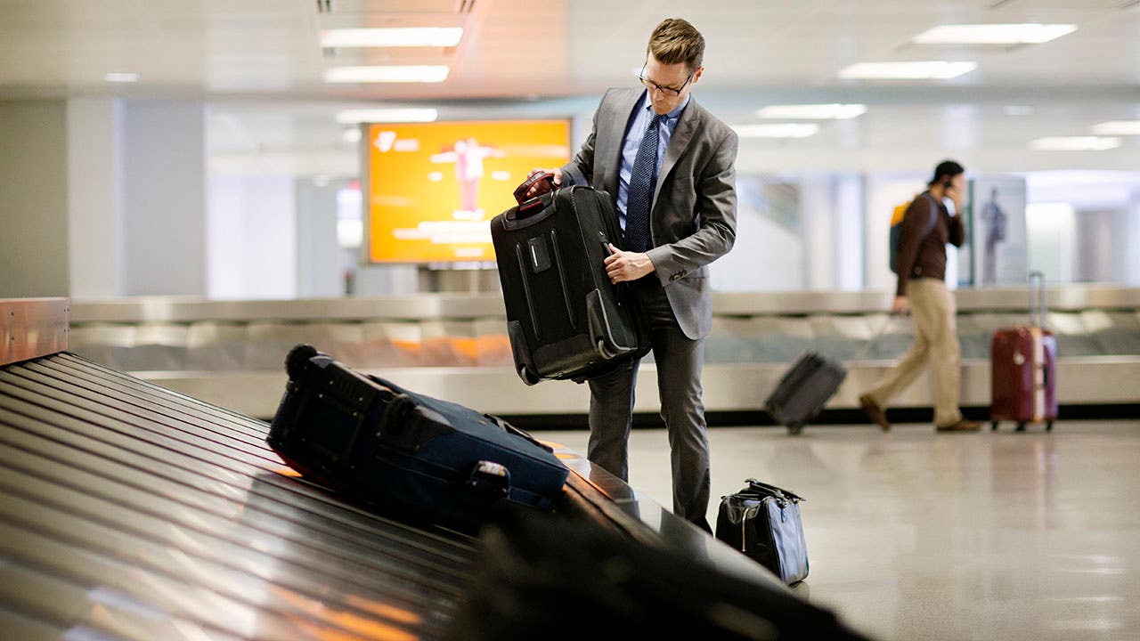 businessman at airport baggage claim
