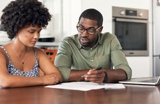 couple looking through paperwork at home