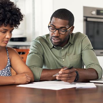 couple looking through paperwork at home