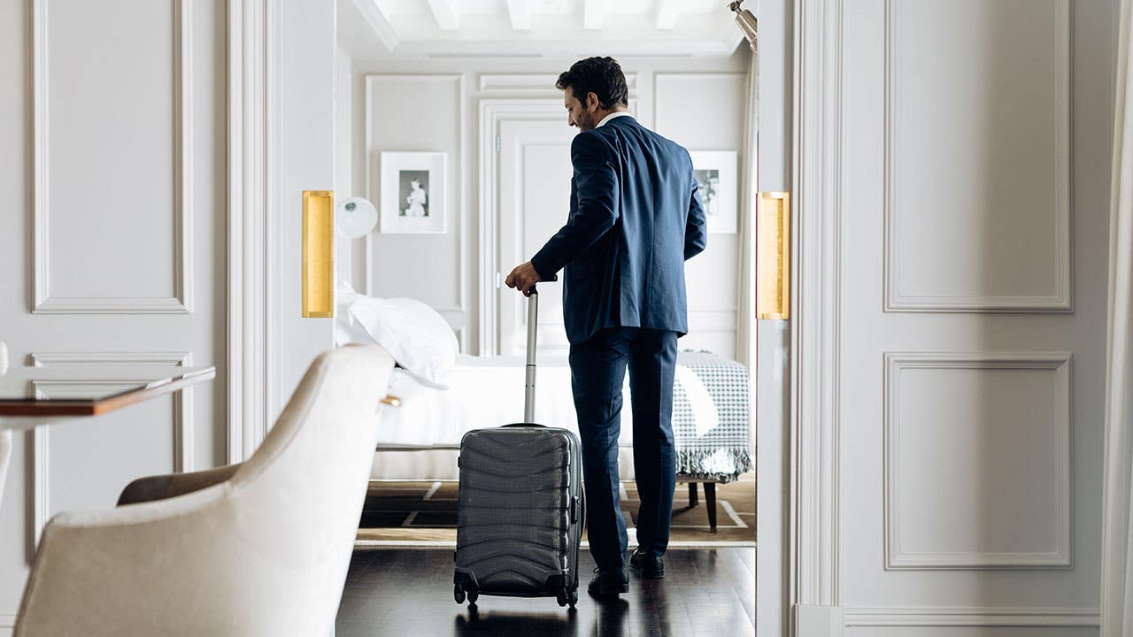 man arriving in a luxury hotel room