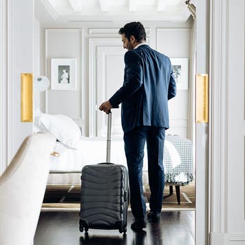 man arriving in a luxury hotel room