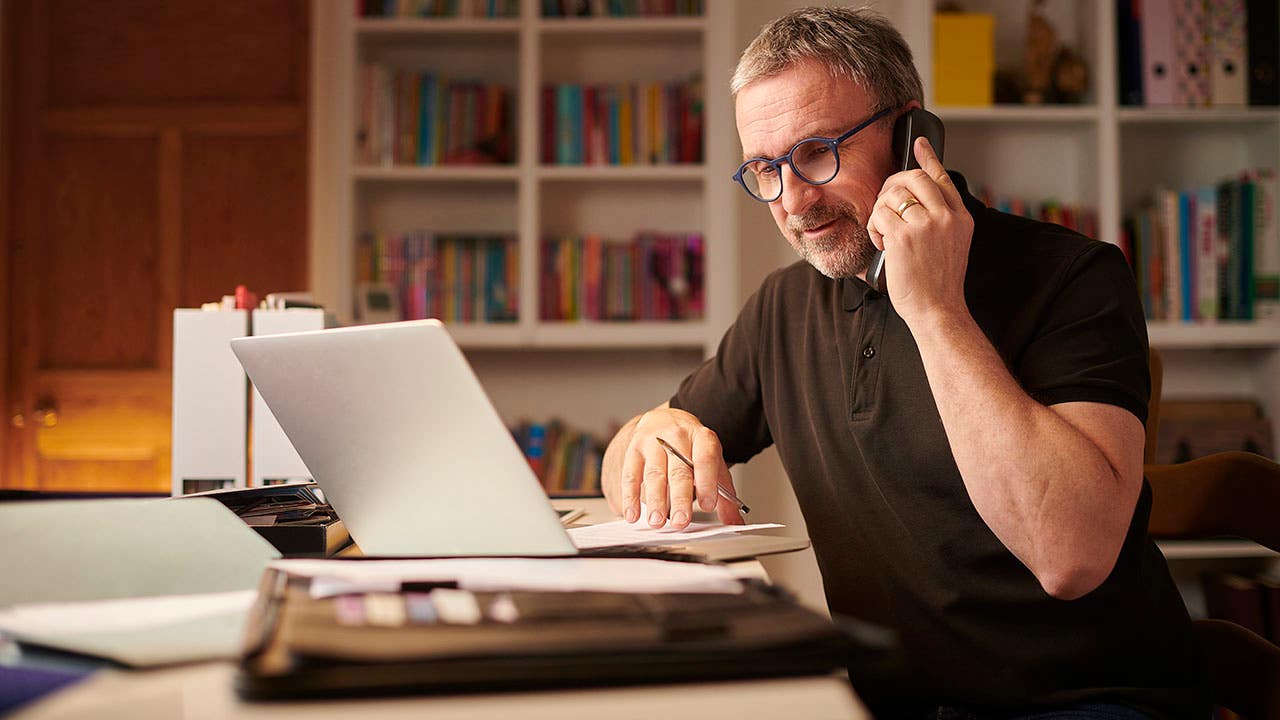 man working on his finances from home