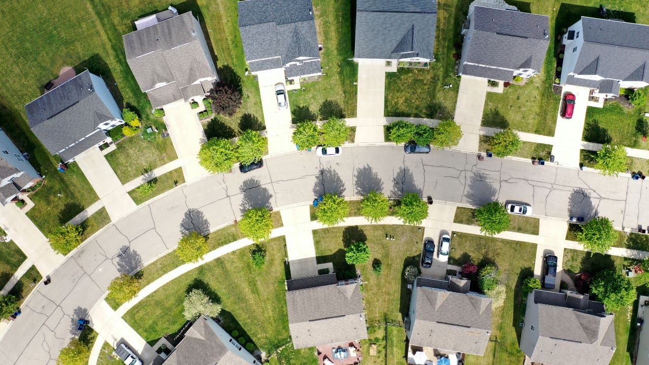 A aerial view of a neighborhood with single-family homes
