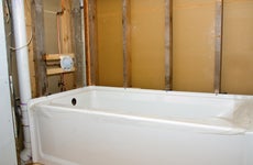 A new tub is installed for a bathroom renovation