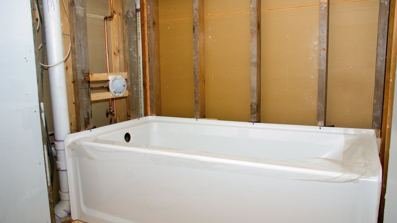 A new tub is installed for a bathroom renovation