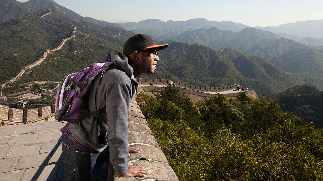 man traveling to the Great Wall of china