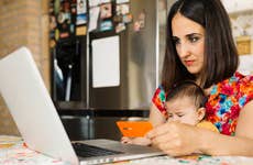 woman shopping online with baby in lap