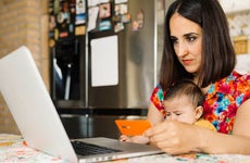 woman shopping online with baby in lap