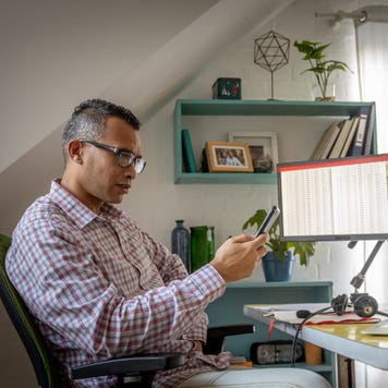 A man trades options from his desk at home