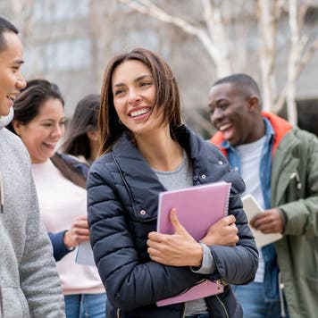 Group of college students walk on campus