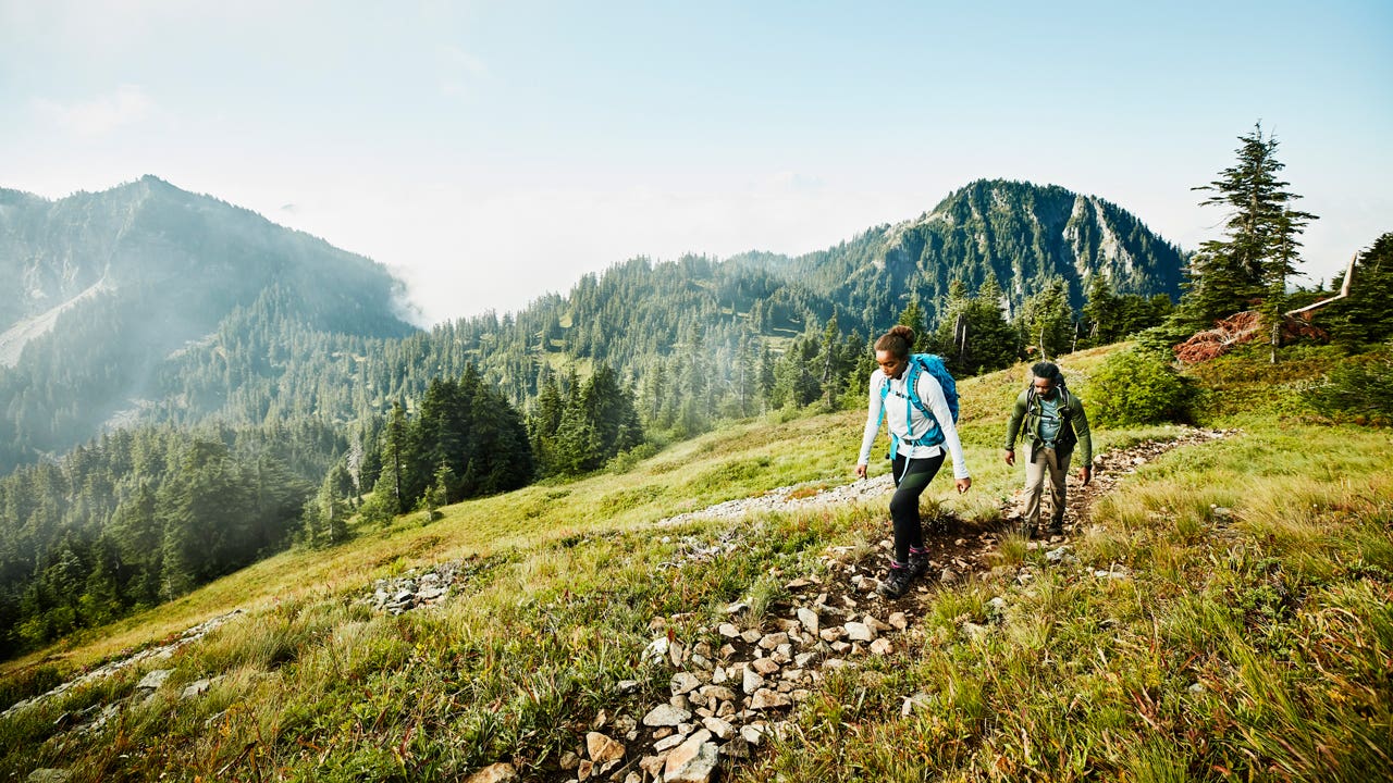 father and daughter hiking in the mountains