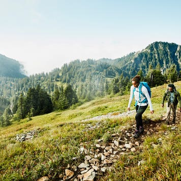 father and daughter hiking in the mountains