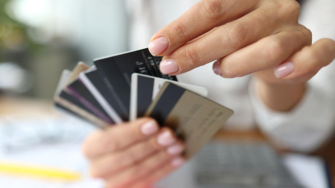 woman holding multiple credit cards