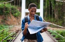 woman looking at a map while traveling