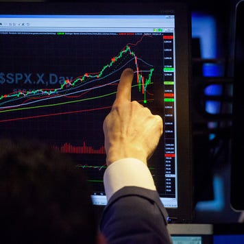 Trader points at stock chart