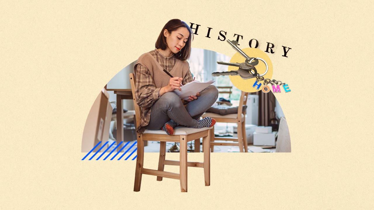 A woman sitting on a chair, reviewing papers