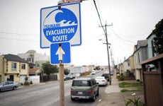a tsunami evacuation sign on a street