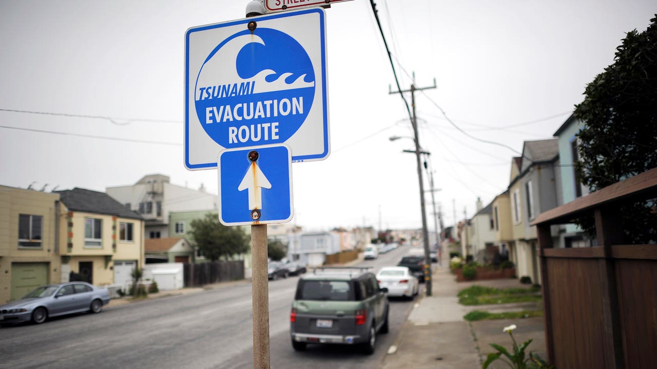 a tsunami evacuation sign on a street