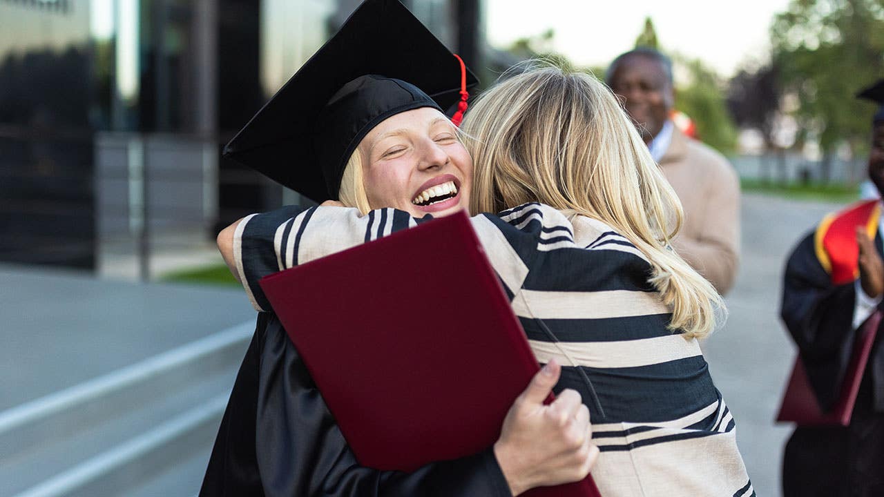 woman hugging her mother at college graduation