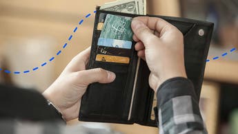 person reaching into a wallet