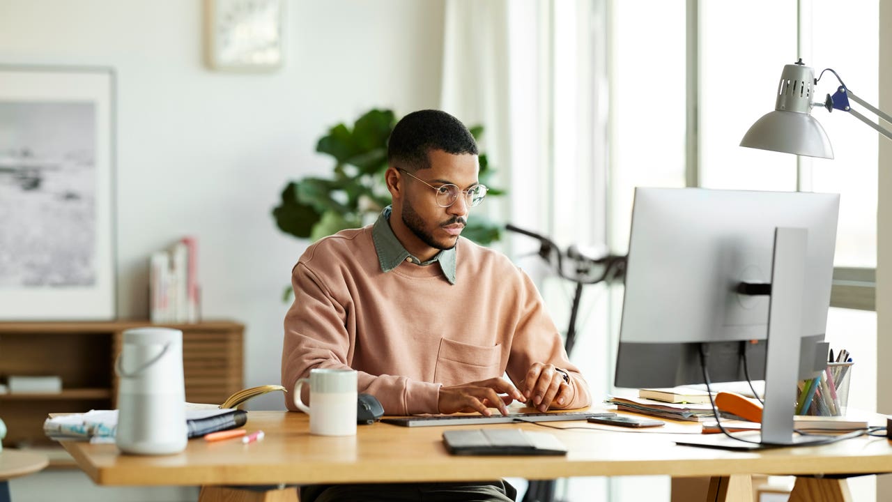 man working on computer at home