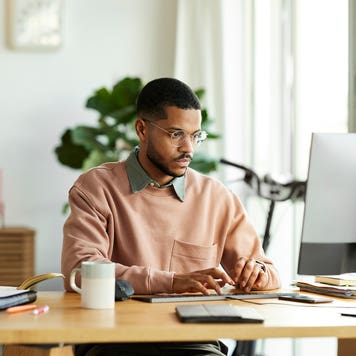 man working on computer at home