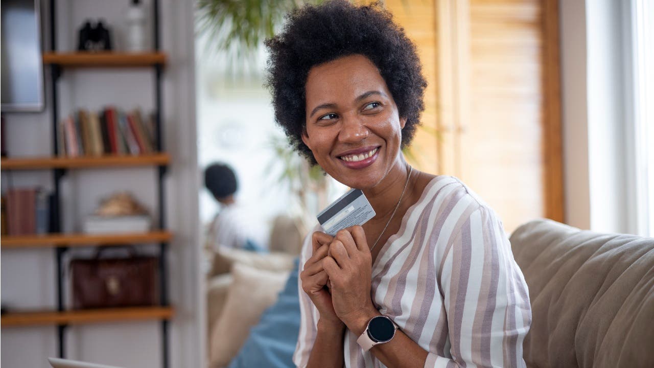 Smiling woman holding credit card