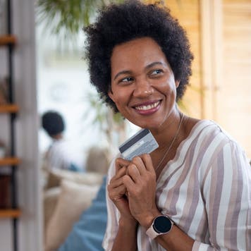 Smiling woman holding credit card