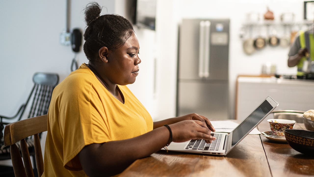 young woman using a laptop at home