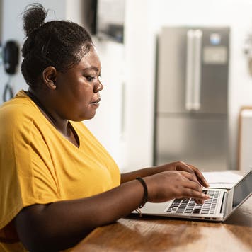 young woman using a laptop at home