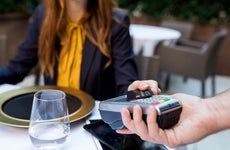 woman at restaurant paying with credit card