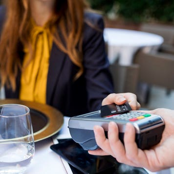 woman at restaurant paying with credit card